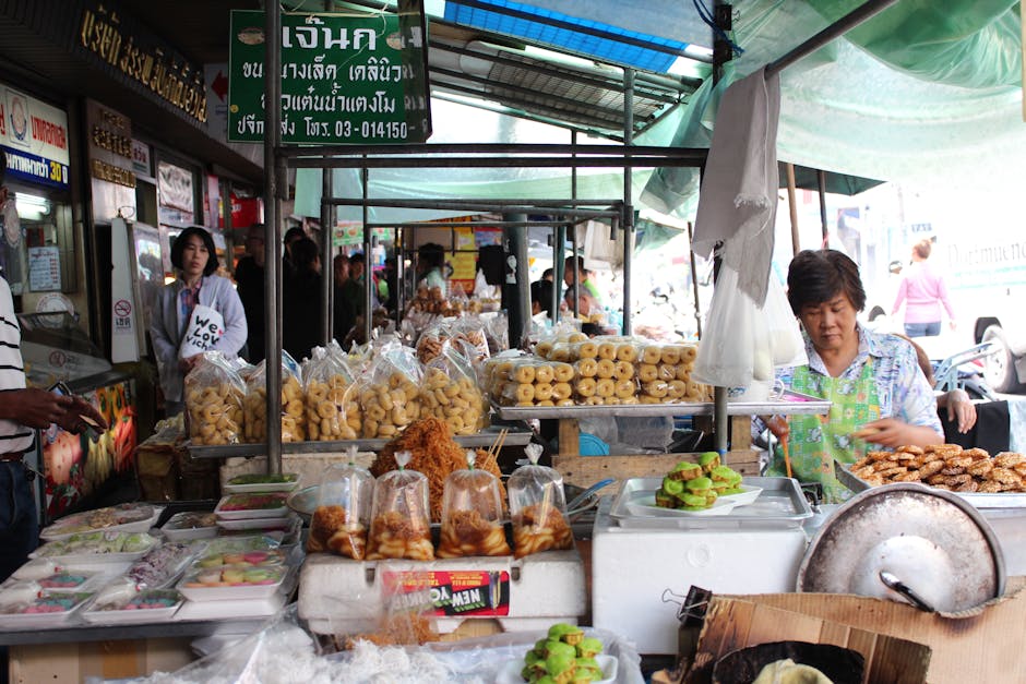 Explore the vibrant street market in Bangkok with diverse Thai food stalls offering traditional cuisine.