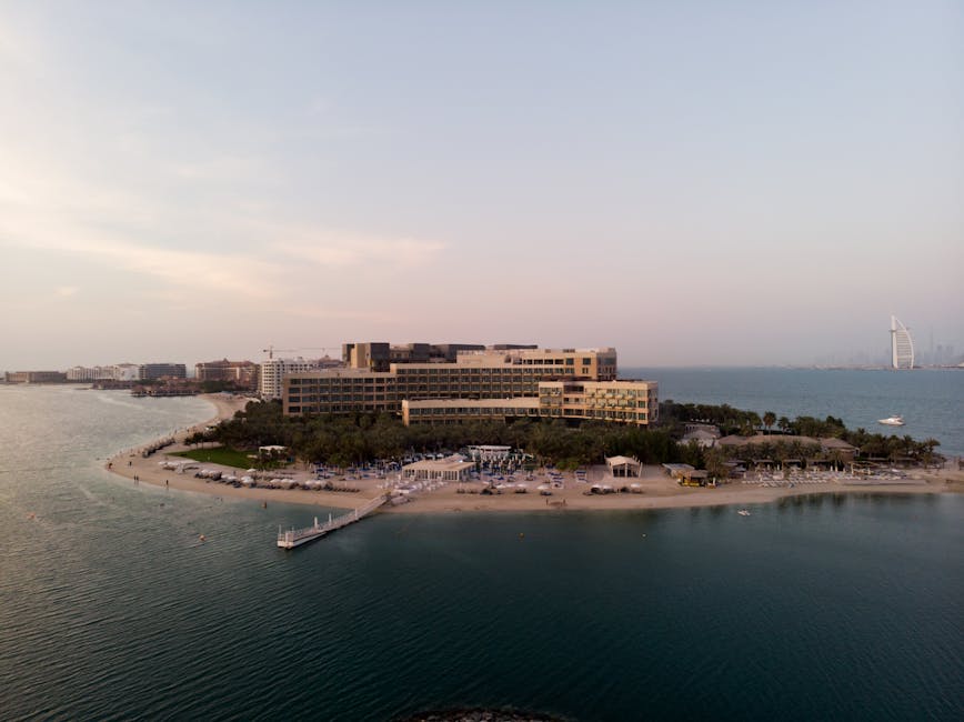 Stunning aerial shot of a luxury beachfront hotel and skyline in Dubai.